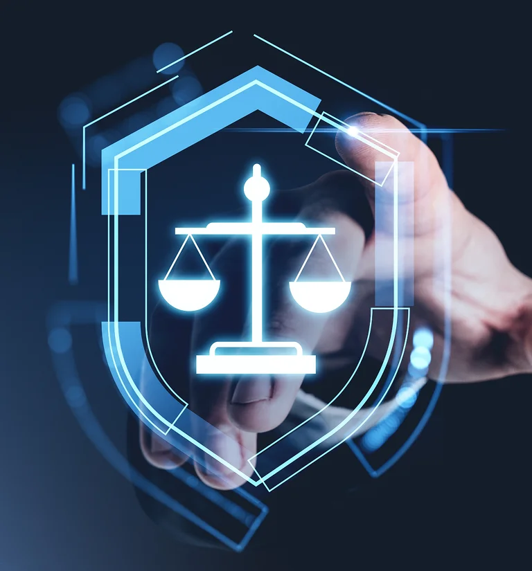 Hand pointing at glowing blue digital scales of justice icon within a shield interface.